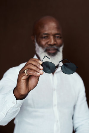Work hard and youll have a bright future. Studio shot of a mature businessman posing against a brown background.の写真素材