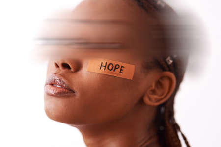Pain is real but so is hope. a young women posing in studio.の写真素材
