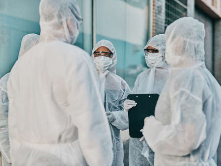 Health and safety personnel in protective gear ready to fight a virus, outbreak or pandemic. Hazmat...