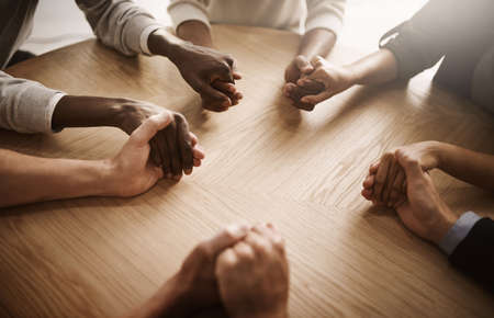 Care, support and teamwork by group of people holding hands in a circle. Community, trust and strength in togetherness, team with a vision or idea. Partnership between ambitious colleagues huddlingの写真素材