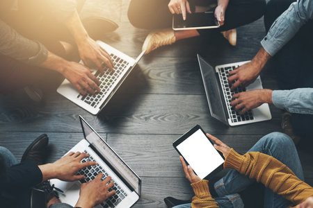 Above group of colleagues working together on a project or business meeting using wireless...