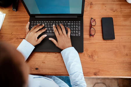 All the info an entrepreneur needs to stay current. a businesswoman using a laptop while working from home.の写真素材
