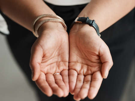 Please contribute if you are able to. Closeup shot of an unrecognisable businesswoman standing with her hands cupped together.の写真素材