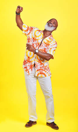Ive still got all the moves. Full length shot of a funky and stylish senior man dancing in studio...