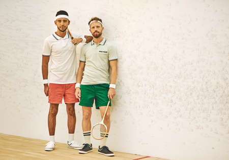 Theres nobody like a squash buddy. two confident young men standing together at a squash court.