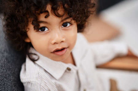 Im always ready for playtime. Portrait of an adorable little boy relaxing and enjoying himself at...