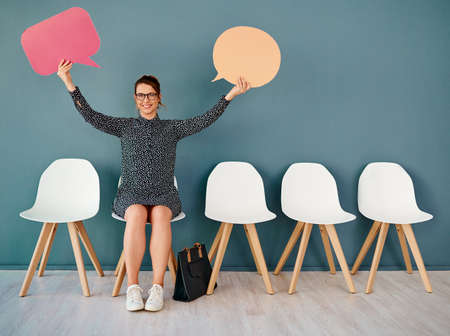I have two big announcements to make. Studio portrait of an attractive young businesswoman holding...