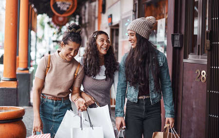 Weve spent so much money but who cares. an attractive group of sisters bonding together during a shopping spree in the city.の写真素材