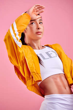 All your efforts will leave you glowing. Studio shot of a sporty young woman wiping her forehead...