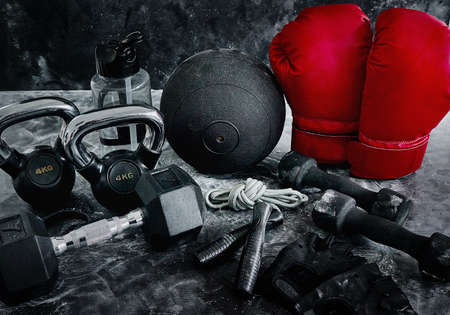 The gloves is all you need. High angle shot of boxing essentials placed on top of a dark background inside of a studio.の写真素材