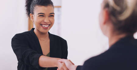 Its been great working with you. an attractive young female financial advisor smiling while shaking hands with her client in her office.の写真素材