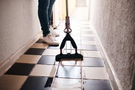 Keeping a clean home. an unrecognizable man mopping the floor at home.の写真素材
