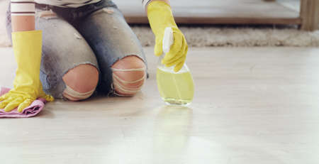 I keep my floors clean at all times. a young woman cleaning her floors at home.の写真素材
