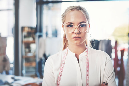 Work until everyone knows your name. a successful young fashion designer in her workshop.