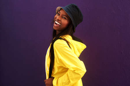 Happy is my favorite mood. an attractive young woman posing against a purple background.