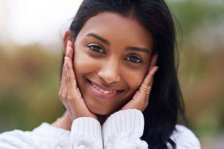 Theres so many beautiful reasons to be happy. a beautiful young woman standing outdoors.