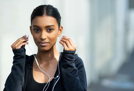 Im ready to pump up the power. Portrait of a sporty young woman listening to music while exercising...
