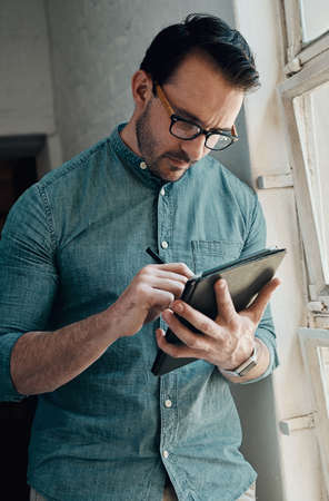 This is simply the best tool for a modern architect. a handsome young businessman using a digital...