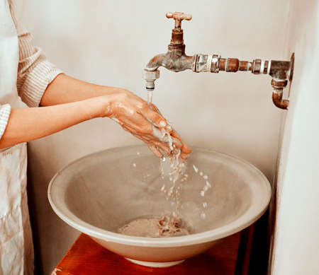 You cant have fun without getting dirty. an unrecognizable woman washing her hands.の写真素材