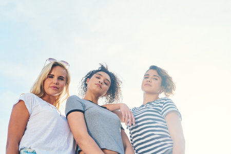 We bring the heat. three friends spending the day together on a sunny day.の写真素材