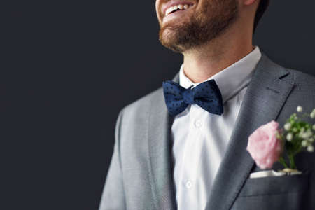 The smile on my face says it all. an unrecognizable bridegroom smiling and feeling cheerful on his wedding day.の写真素材