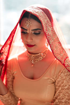 Theres something magical about a traditional Indian wedding. a beautiful young woman getting ready for her wedding.の写真素材