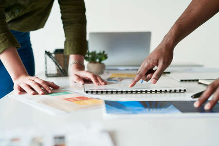 Thats the sector we need to target. two unrecognizable businesspeople using a digital tablet and going over paperwork together a work.の写真素材