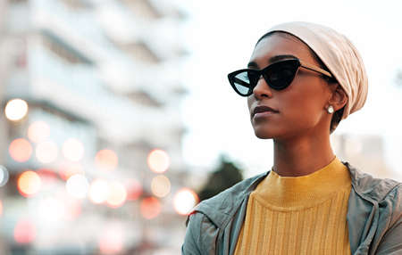 Feeling chic and confident. an attractive young woman wearing a hijab and sunglasses while touring the city.の写真素材