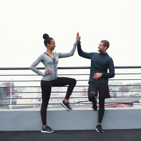 The benefits of exercise linger long after. a sporty young man and woman giving each other a high...