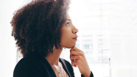 Mindfulness is a must in creating clear strategies. a young businesswoman strategising on a whiteboard in a modern office.の写真素材