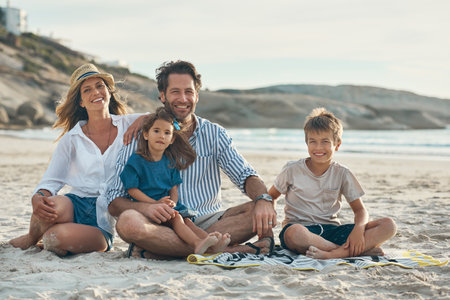 Our children will forever be our always. Full length portrait of an affectionate couple sitting with their two children and enjoying a day on the beach together.の写真素材