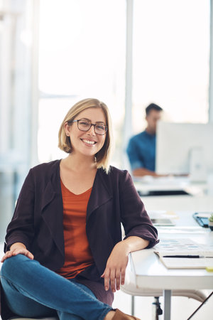 Confident and smiling businesswoman, executive or corporate leader with success, leadership and confidence in a work office. Face portrait of a smart creative research analyst, manager or bossの写真素材