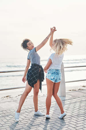 Appreciate the people you have around you. two friends spending the day together on a sunny day.の写真素材