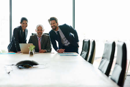 Group of happy corporate businesspeople planning ideas. Executives leading brief with multiple...