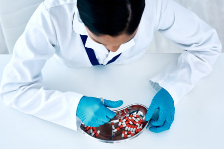 High angle shot of an unrecognizable female pharmacist counting medication in a chemist.の写真素材