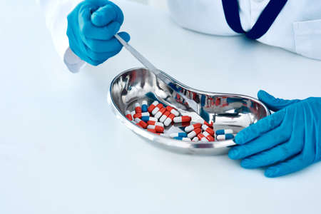 Shell dispense only the correct amount of medication. an unrecognizable female pharmacist counting medication in a chemist.の写真素材
