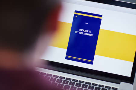 Never lose track of your package again. an unrecognizable person tracking a delivery via laptop.の写真素材