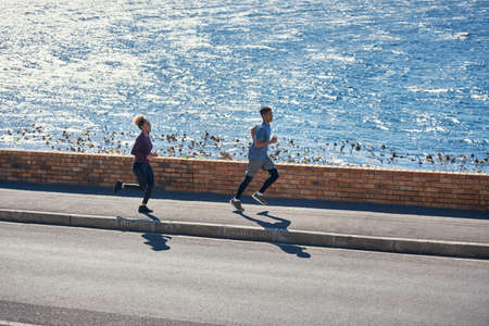 Theyre good for each other. a young couple out for a run together.の写真素材