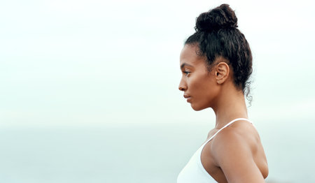 Try to live a more balanced lifestyle. a sporty young woman exercising outdoors.の写真素材