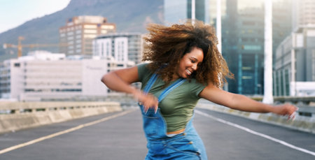 Dance more, stress less. an attractive young woman performing a street dance routine during the day while outdoors.の写真素材