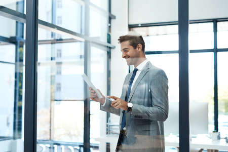 I plan better when using my favorite tool. a professional businessman using a digital tablet in his...