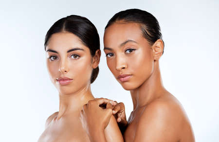Real beauty is inclusive beauty. Studio shot of beautiful young women posing against a grey background.の写真素材
