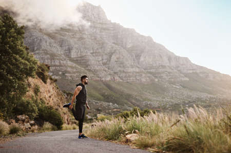 Man is nothing but what he makes of himself. a sporty young man exercising outdoors.の写真素材