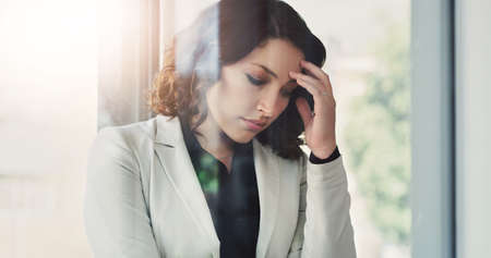 This feeling is more than she can handle. an attractive young businesswoman feeling stressed out at...