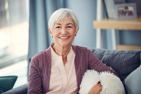 Seventy is the new fifty. Cropped portrait of a happy senior woman relaxing comfortably on her couch...