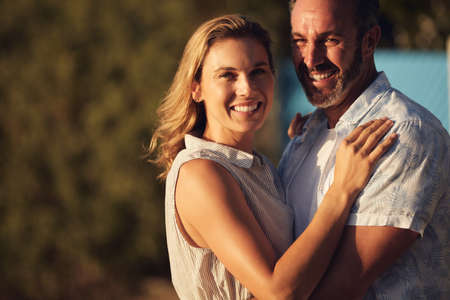 The sun and his arms around me is all I need. an affectionate mature couple spending some quality time together.の写真素材