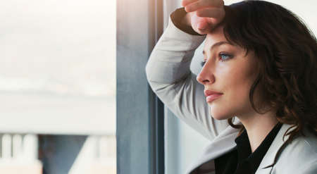 Work has never been so unenjoyable. an attractive young businesswoman feeling depressed at work.の写真素材