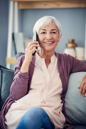 Talking to her grandkids is always a delight. a happy senior woman taking a phonecall while relaxing...
