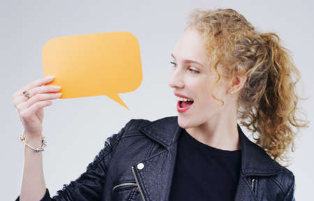 I wouldve never guessed that. an attractive young woman looking surprised while holding a speech...