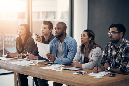 Id like to see more of that. a group of young businesspeople having a meeting in a modern office.の写真素材